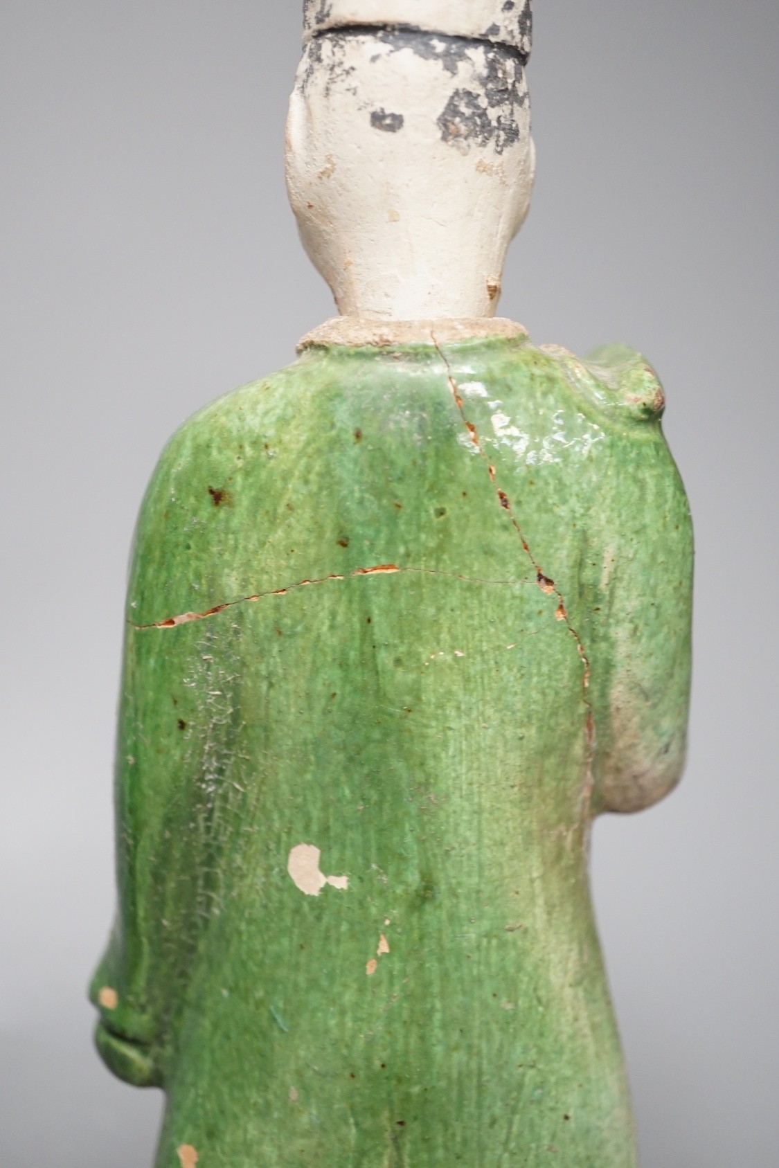 Three Chinese Ming pottery figures of attendants, 28cm tall